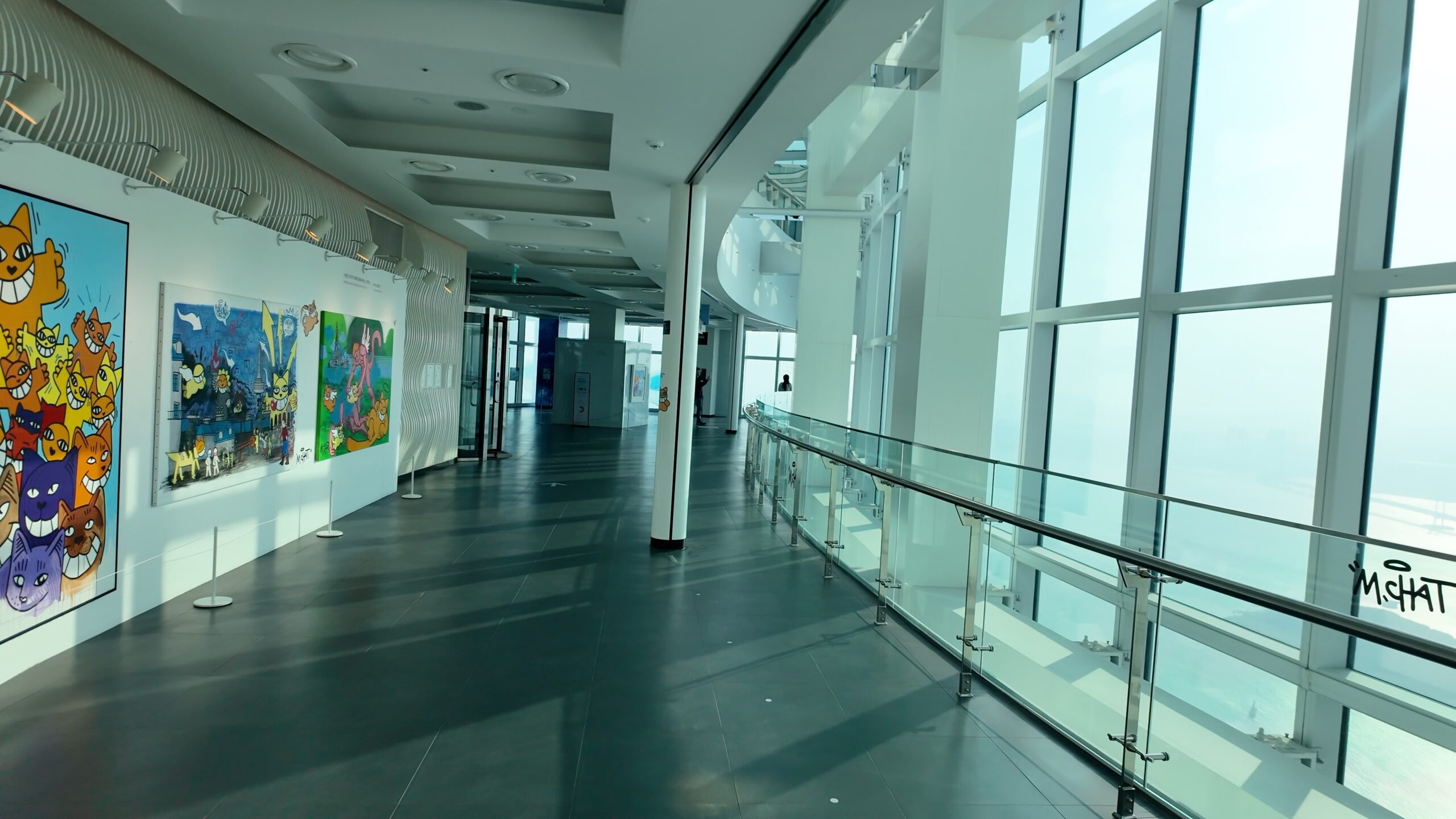100階展望フロアのアート展示と開放的なガラス張りの空間